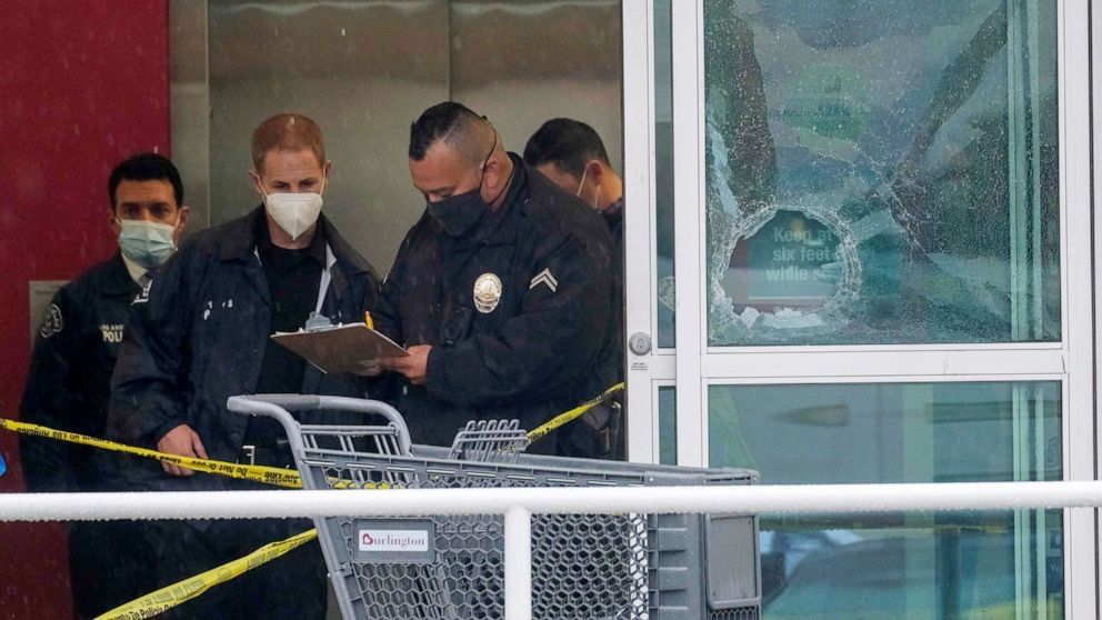 Officers standing in a doorway with damage