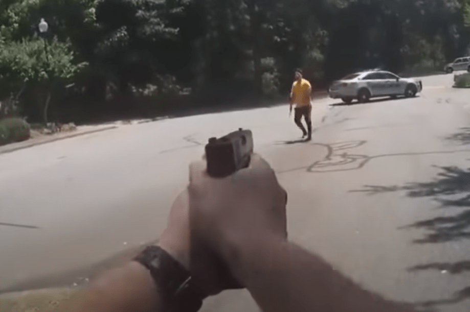 officer aiming at man with knife
