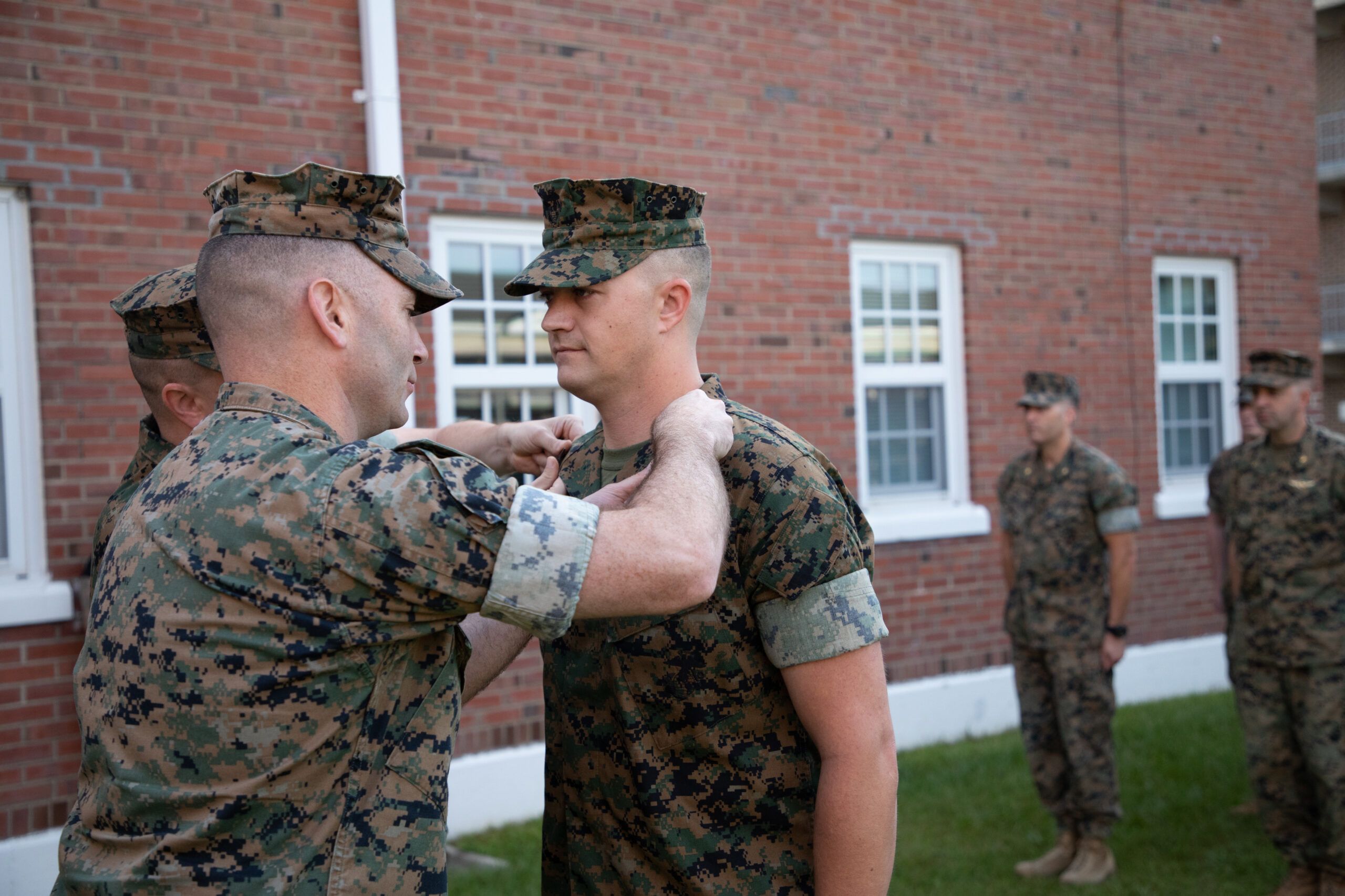 United States Marine being promoted to the next higher rank in a formation.