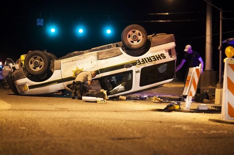 A sheriff Department vehicle on its' roof following a collision