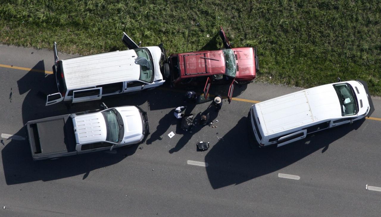 3 white vehicles surrounding a red car. The red car belongs to a bomber in Austin TX who activated a device when the 3 surrounding police cars attempted to take him into custody. 