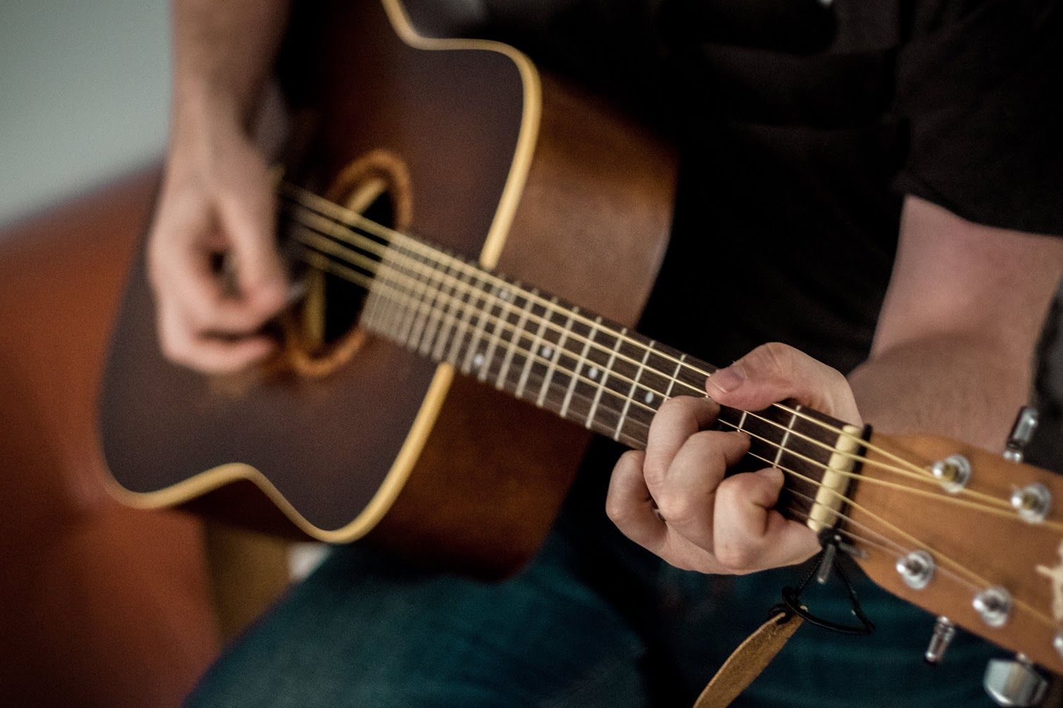 Man playing acoustic guitar.